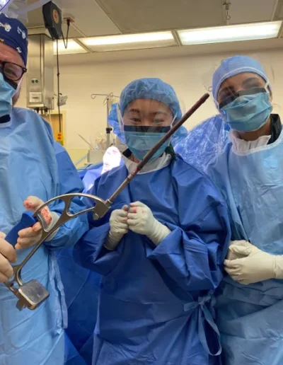 Replacement surgery team with tools in OR.