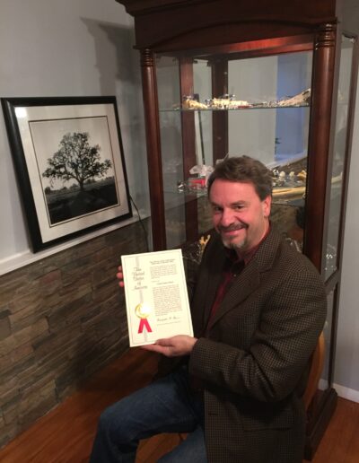 Steve Corsello holding Activize's Certificate from U.S. Patent and Trademark Office.